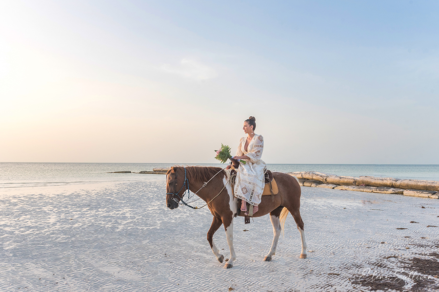 bride riding horse beach
