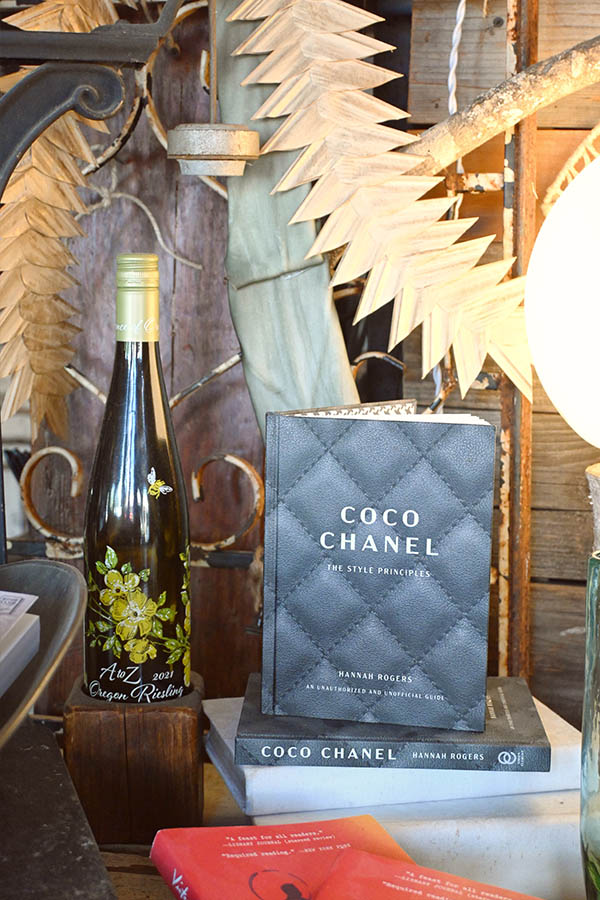 decorative-display-featuring-a-2021-A-to-Z-Oregon-Riesling-wine-bottle-and-a-book-titled-Coco-Chanel-The-Style-Principles-by-Hannah-Rogers