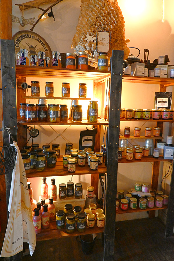 rustic-store-display-with-multiple-wooden-shelves-filled-with-various-jars-and-bottles-of-food-