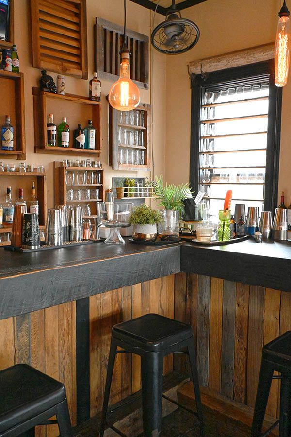 rustic-style-bar-or-counter-with-a-dark-wooden-top-and-reclaimed-wood-planks-on-the-front