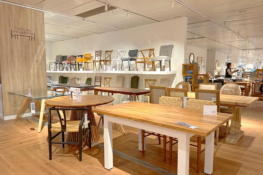 Modern-retail-furniture-showroom-showcasing-a-variety-of-wooden-dining-tables-paired-with-different-chair-styles-including-woven-seats
