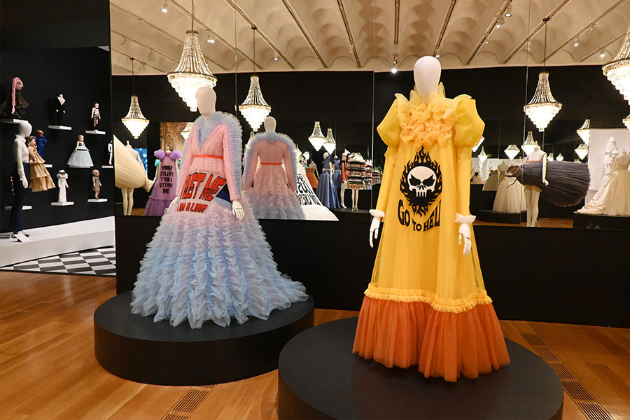 bold-slogan-gowns-and-crystal-chandeliers-in-mirrored-gallery-installation
