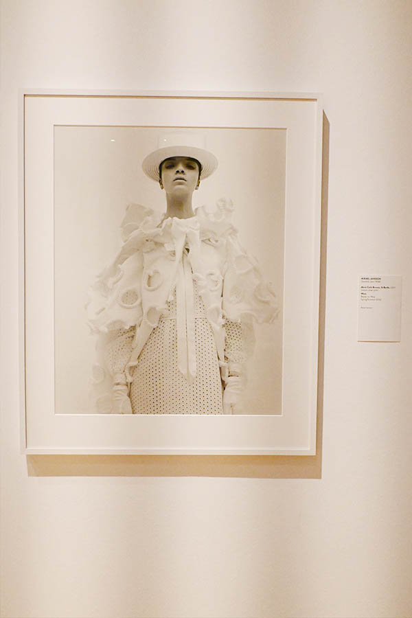 framed-black-and-white-portrait-of-model-in-ruffled-white-couture-with-top-hat