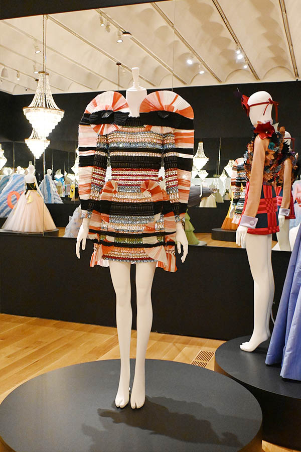 jewel-encrusted-striped-mini-dress-with-exaggerated-pleated-shoulders-on-circular-podium