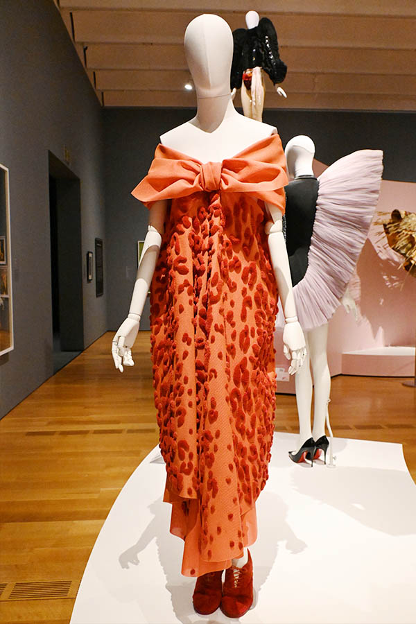 off-the-shoulder-orange-animal-print-gown-with-large-bow-detail-on-mannequin