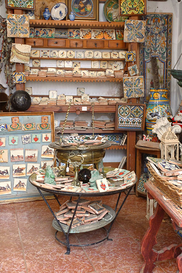 rustic-indoor-shop-display-filled-with-an-abundance-of-hand-painted-ceramic-tiles-featuring-intricate-patterns-birds