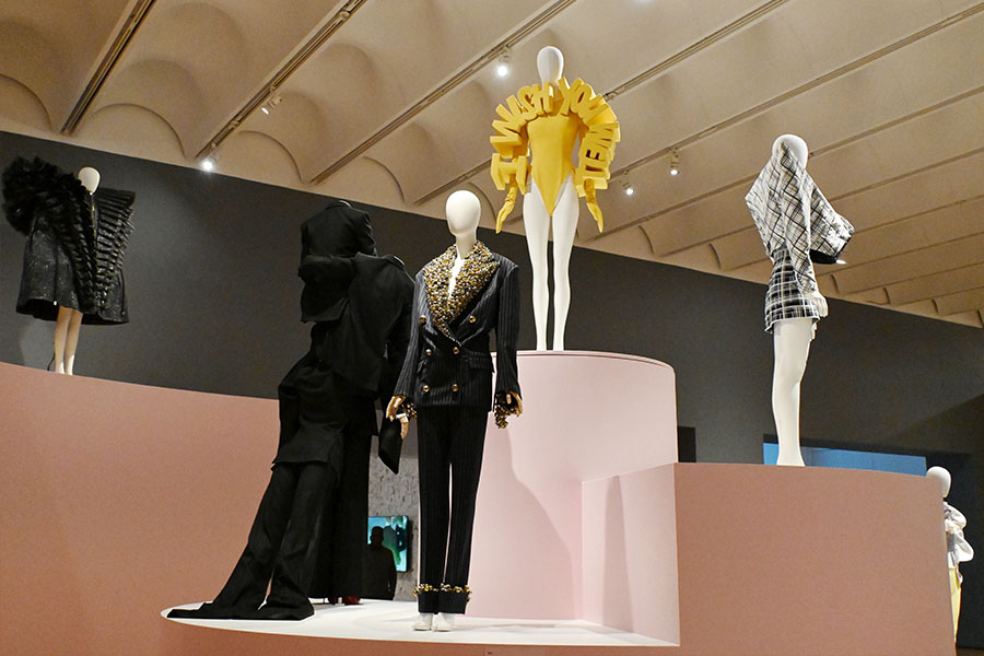 sculptural-yellow-bodysuit-and-embellished-suits-on-tiered-exhibition-podium