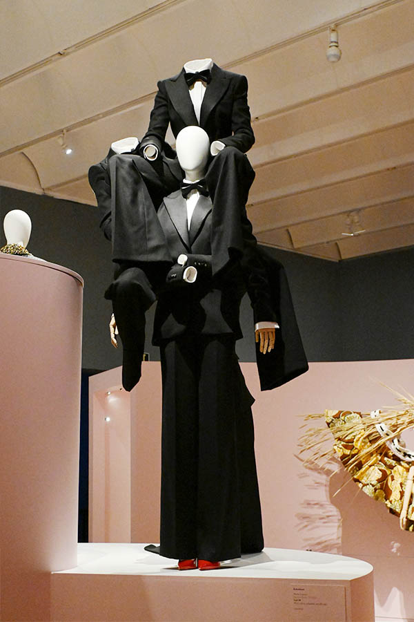 surreal-multi-layered-black-tuxedo-ensemble-on-elevated-exhibition-podium