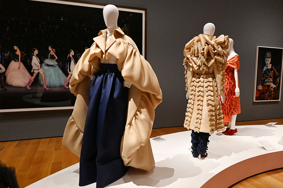 voluminous-tan-and-navy-gown-with-bow-detailed-coat-on-gallery-display