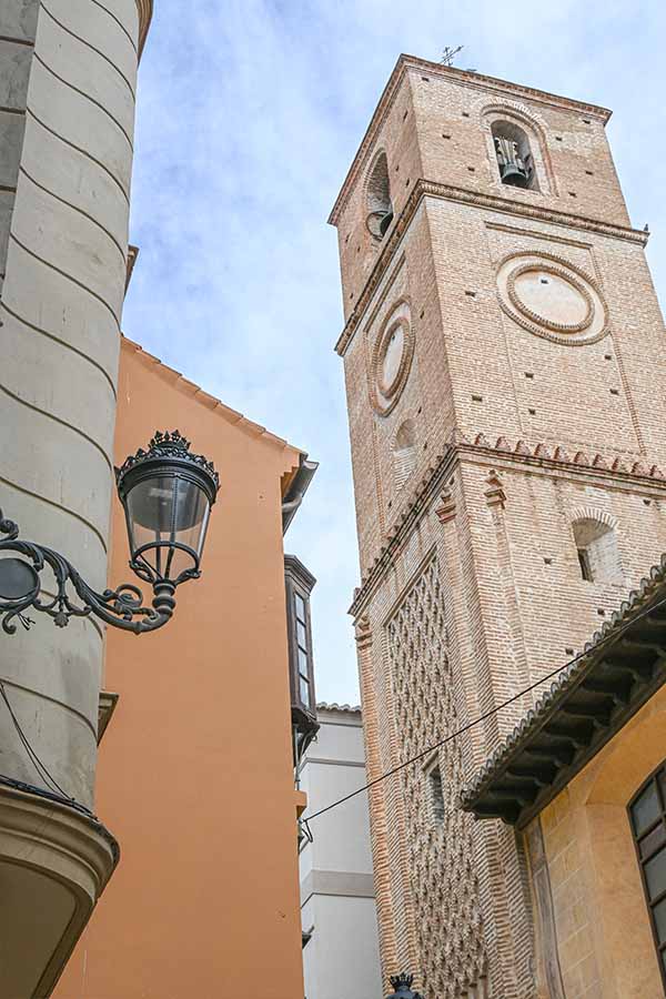 Historic-brick-bell-tower-with-ornate-Mudejar-detailing-Malaga-Spain