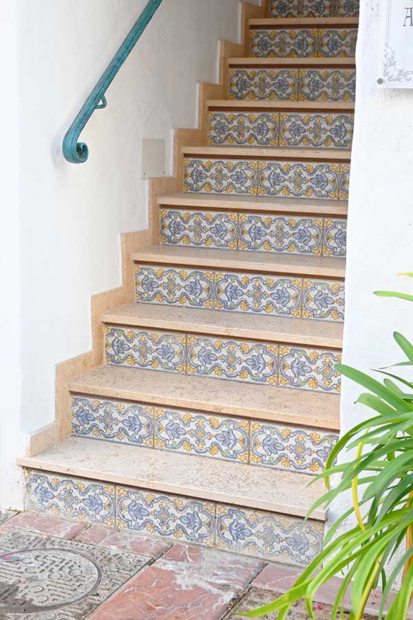 Indoor-stone-staircase-featuring-decorative-blue-and-yellow-floral-tiled-risers