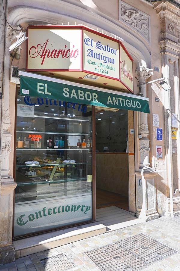 Traditional-confectionery-shopfront-with-a-prominent-sign-reading-El-Sabor-Antiguo-Aparicio
