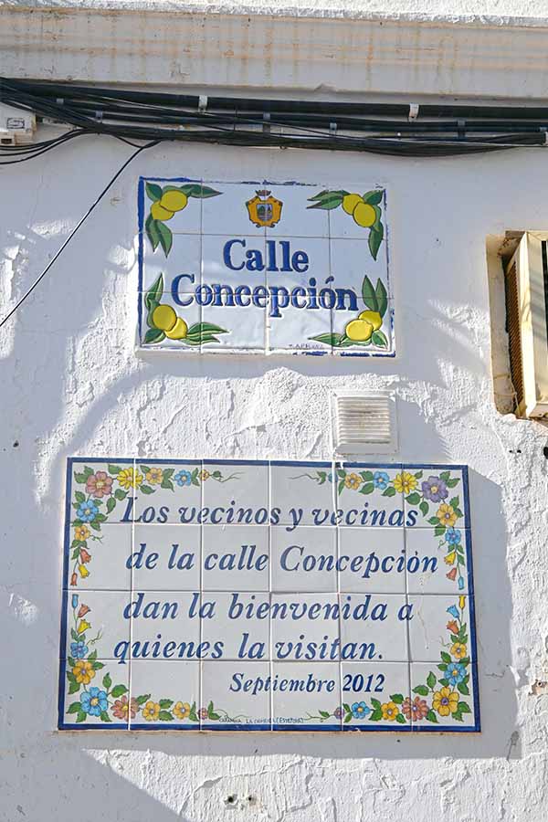 Two-tiled-plaques-on-a-white-wall-with-the-top-one-reading-Calle-Concepción-Estepona-spain