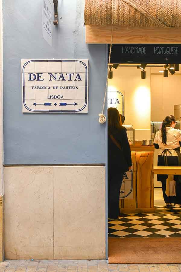bakery-entrance-with-a-blue-wall-tiled-sign-De-nata-Malaga-Spain