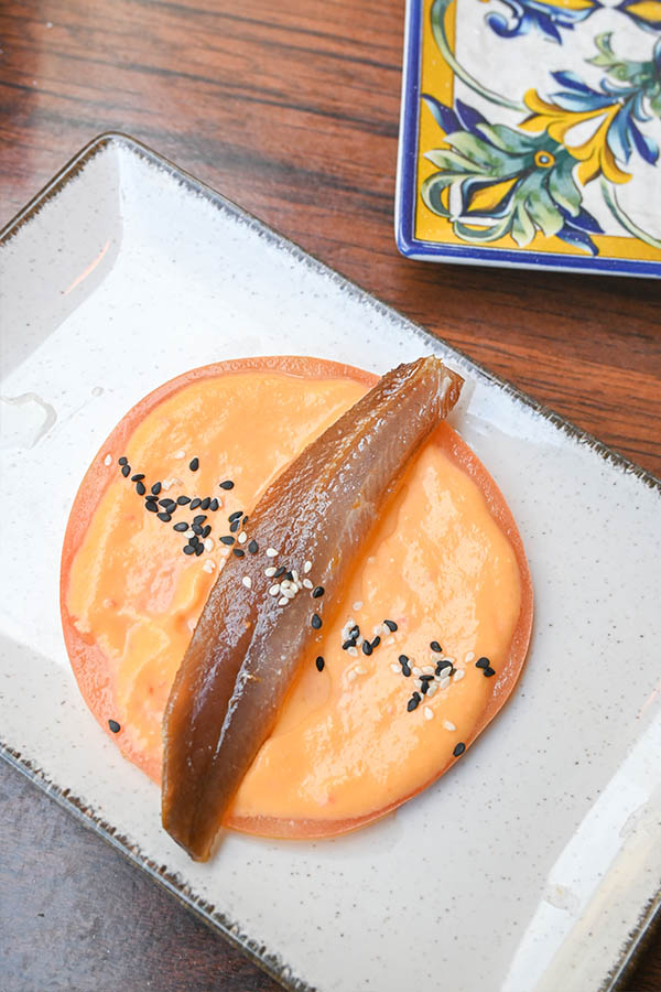 smoked-sardine-fillet-salmorejo-cream-tomato-base-black-sesame-seeds-spanish-tapas
