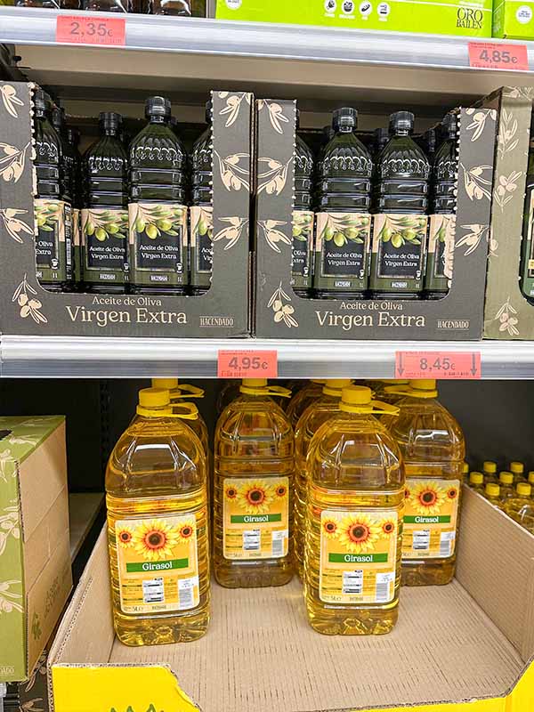 Olive-oil-bottles-sunflower-oil-jugs-supermarket-shelf