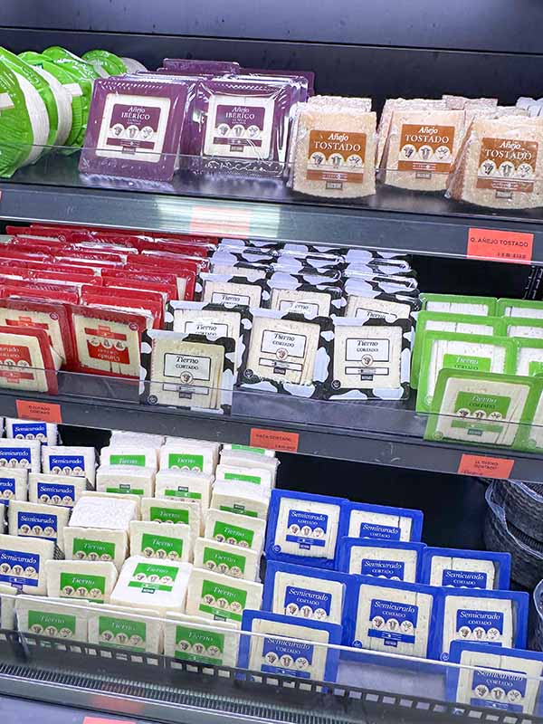 variety-of-pre-cut-and-wedge-cheeses-on-shelves