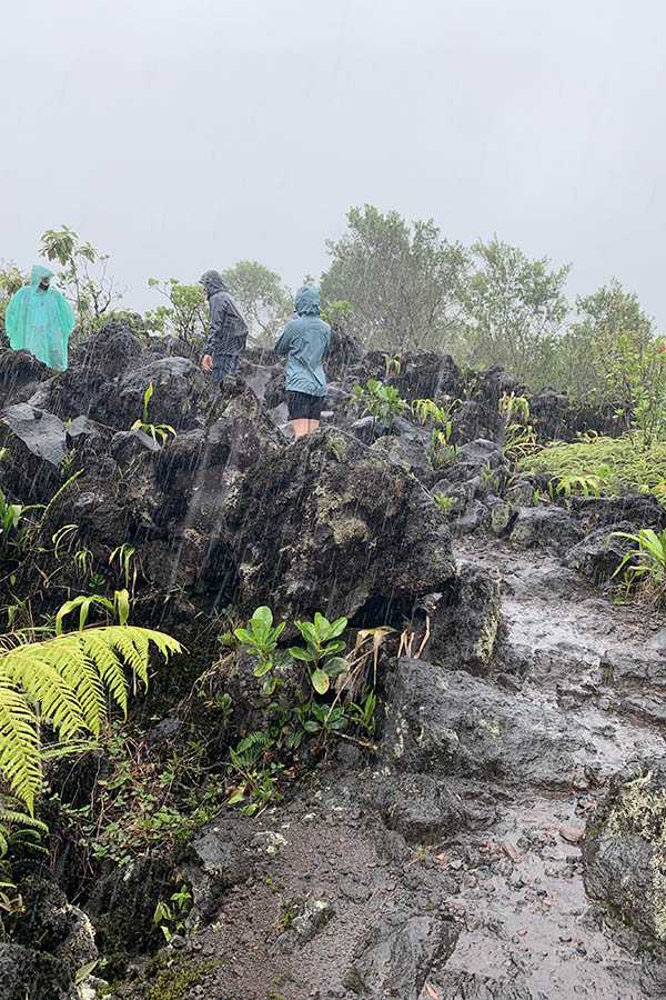 Hikers-in-ponchos-exploring-rugged-volcanic-terrain-in-Costa-Rica