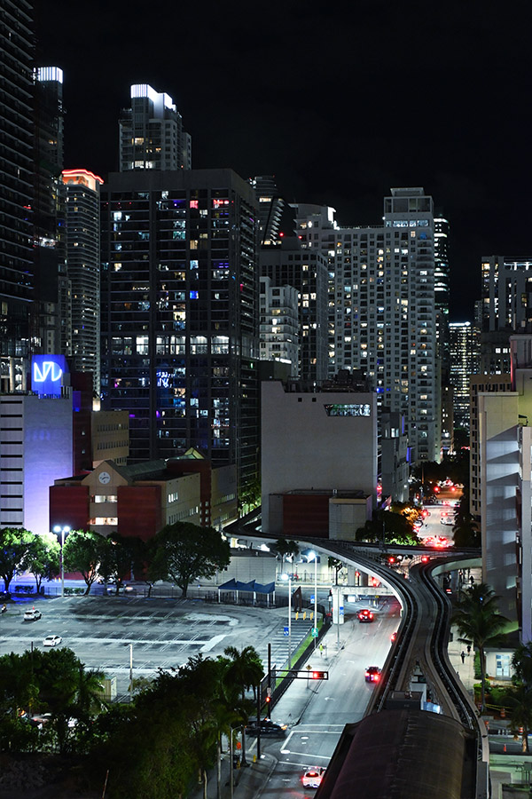 Nighttime-urban-density-showing-the-Metromover-track-winding-through-neon-lit-Miami-architecture-skyscrapers