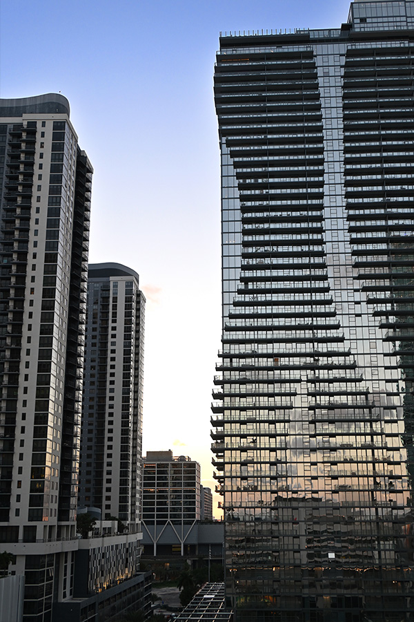 Sleek-glass-facades-and-staggered-balcony-lines-of-modern-Miami-architecture-condominiums-at-dusk