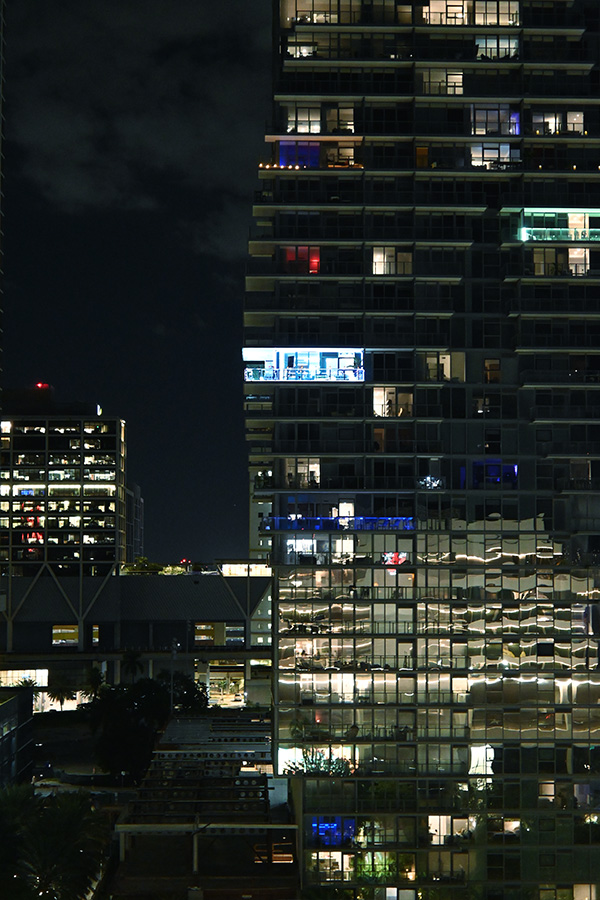 dense-grid-of-illuminated-windows-and-glass-railings-reflecting-the-energy-of-downtown-Miami-architecture