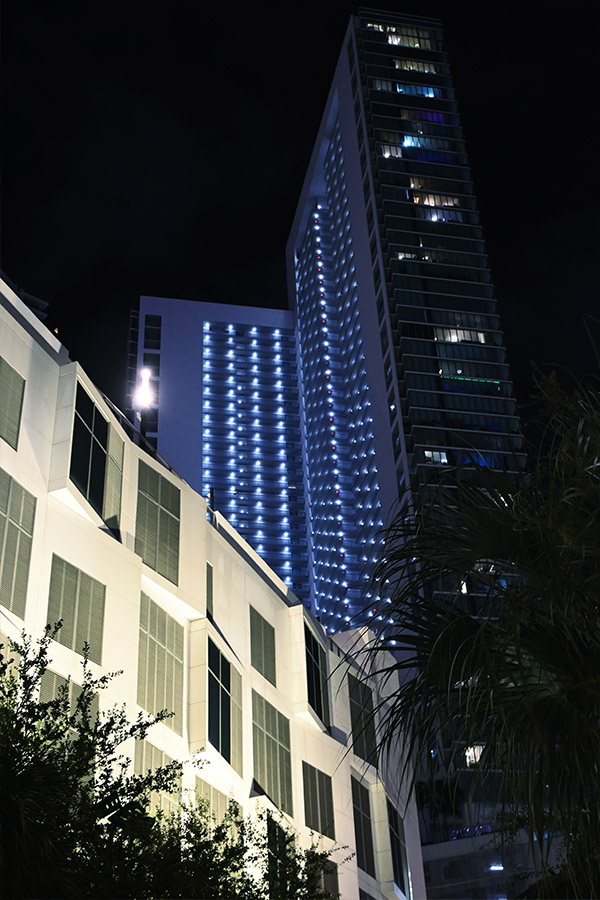 wide-shot-of-luxury-residential-skyscrapers-framed-by-tropical-palm-trees-highlighting-upscale-Miami-Architecture