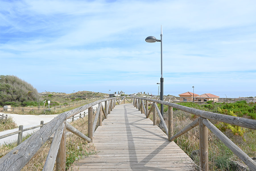 An-elevated-wooden-path-extending-across-the-landscape-near-Spain-best-beaches-Real-de-la-Zaragoza