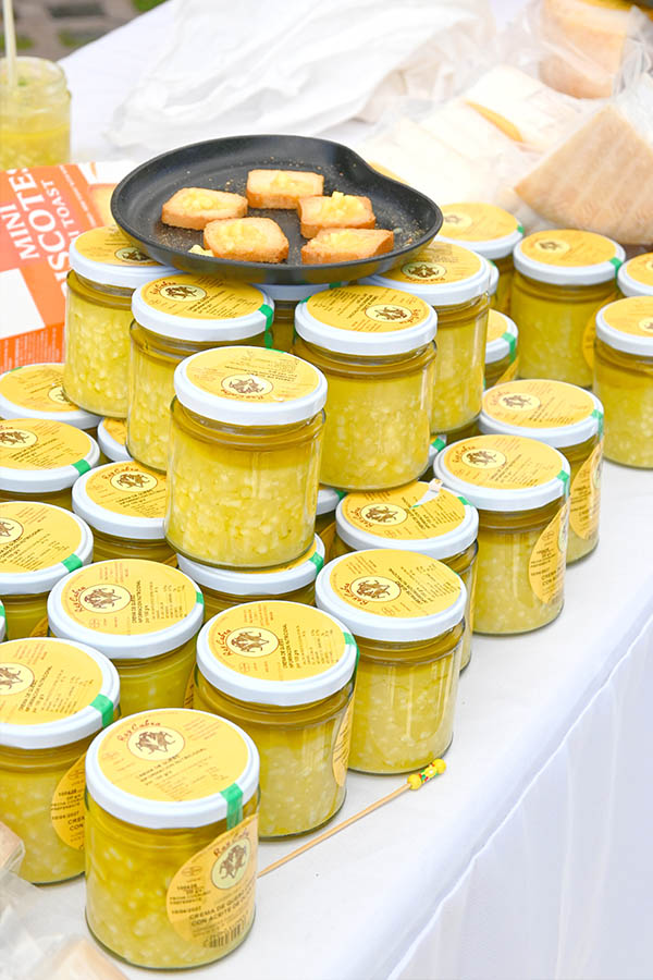 rows-of-glass-jars-filled-with-creamy-yellow-spanish-cheese