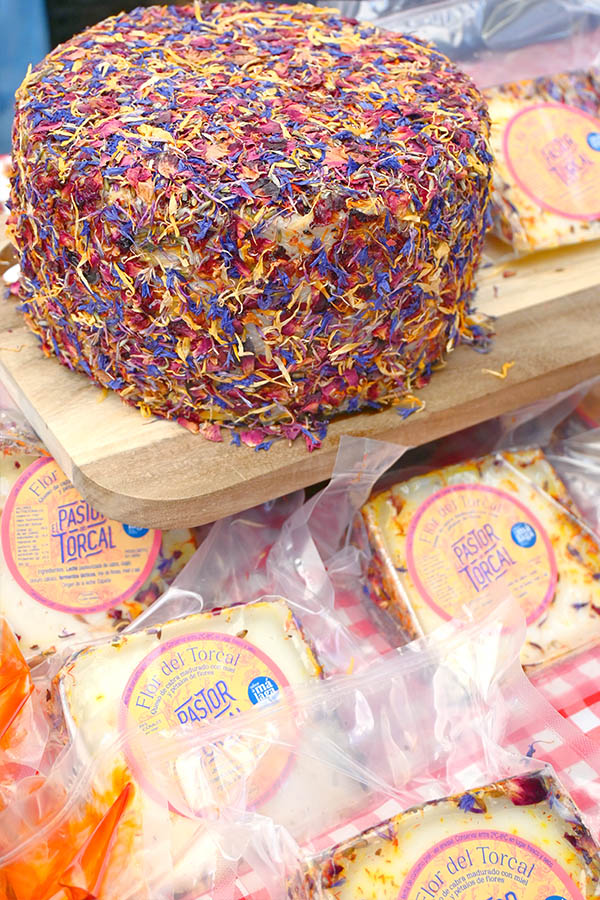 spanish-cheese-coated-with-vibrant-multicolored-flower-petals