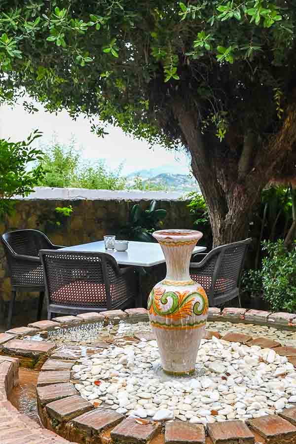beautiful-ceramic-vase-fountain-in-outdoor-garden-patio-at-hotel-castillo-de-monda-spain