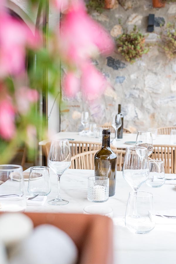 close-up-of-elegant-table-setting-with-wine-glasses-and-bottles-providing-interior-design-inspiration