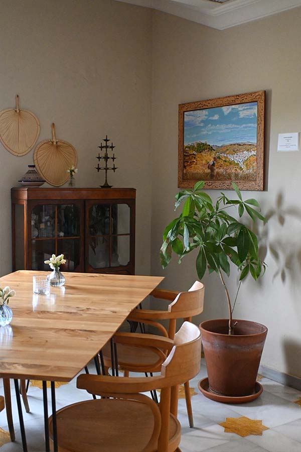 dining-room-corner-with-wooden-table-and-green-houseplant-at-hotel-castillo-de-monda-spain