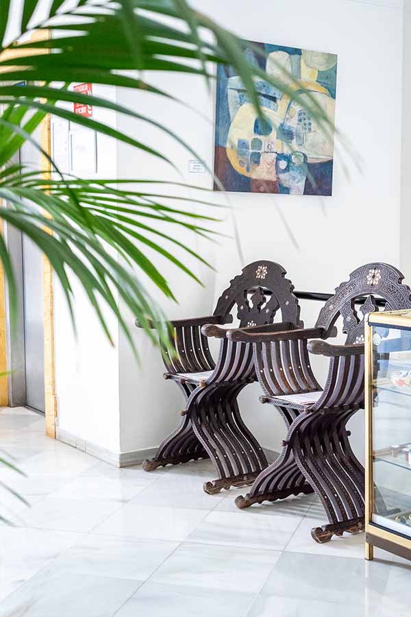 elegant-moorish-style-wooden-chairs-on-white-marble-floor-showing-classic-castle-design