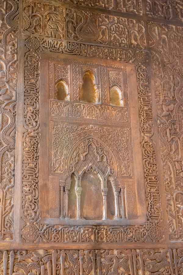 intricately-carved-wooden-wall-panel-with-arabic-calligraphy-showing-classic-castle-design