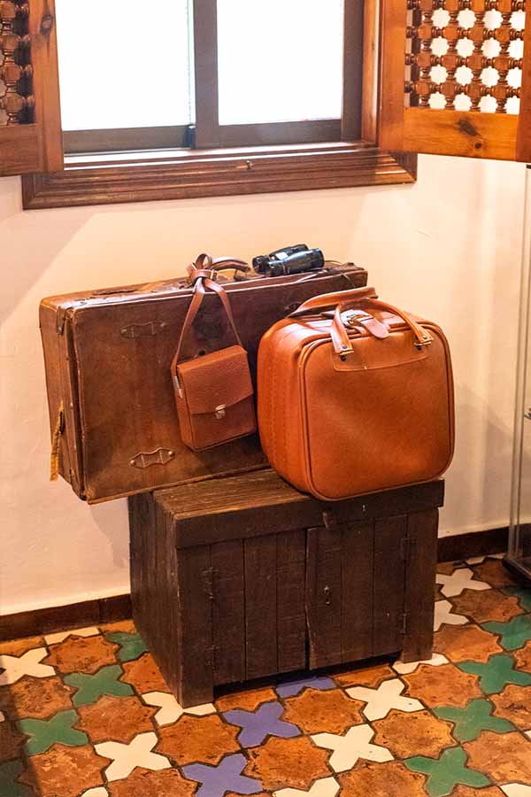 vintage-leather-suitcases-stacked-on-a-rustic-wooden-chest-offering-classic-interior-design-inspiration