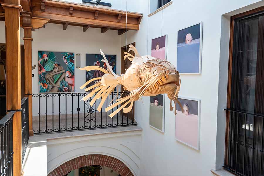 Atrium-balcony-hanging-wooden-fish-sculpture-wall-art-hotel-claude-marbella-spain-boutique-hotel-design-interior-design