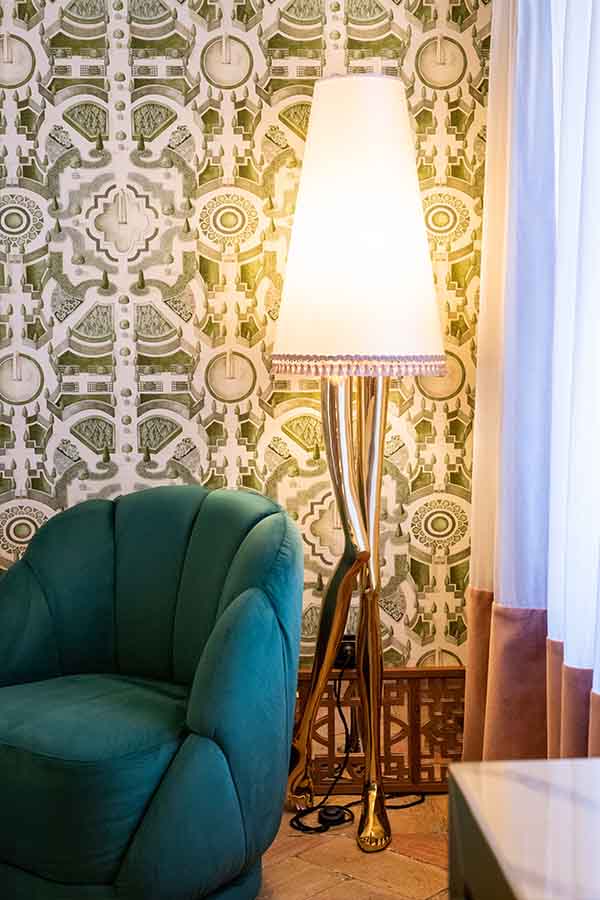Brass-sculptural-floor-lamp-green-velvet-shell-chair-patterned-wallpaper-hotel-claude-marbella-spain-interior-design-boutique-hotel-design