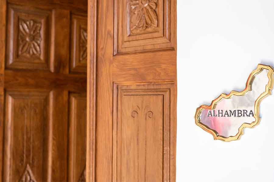 Carved-wooden-door-alhambra-plaque-white-wall-hotel-claude-marbella-spain-interior-design-boutique-hotel-design
