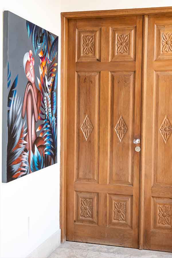 Carved-wooden-double-doors-colorful-tropical-painting-hotel-claude-marbella-spain-boutique-hotel-design-interior-design