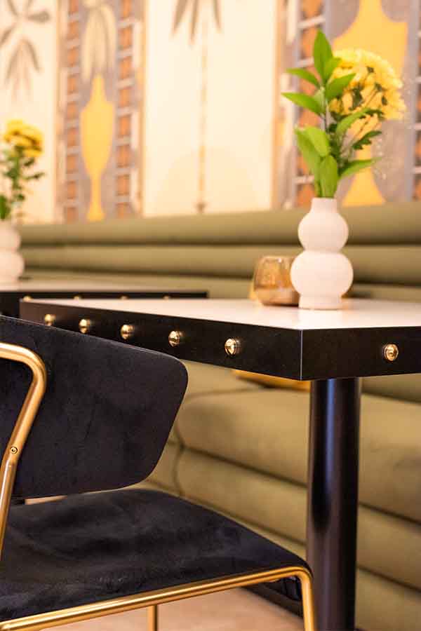 Dining-table-studded-edge-black-velvet-chair-hotel-claude-marbella-spain-interior-design-boutique-hotel-design