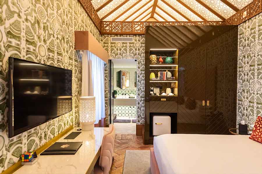 Luxury-bedroom-desk-tv-built-in-minibar-shelves-hotel-claude-marbella-spain-boutique-hotel-design-interior-design