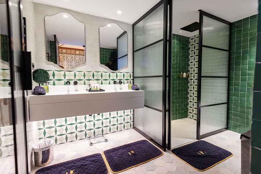 Modern-bathroom-green-tiles-fluted-glass-shower-doors-double-vanity-hotel-claude-marbella-spain-interior-design-boutique-hotel-design