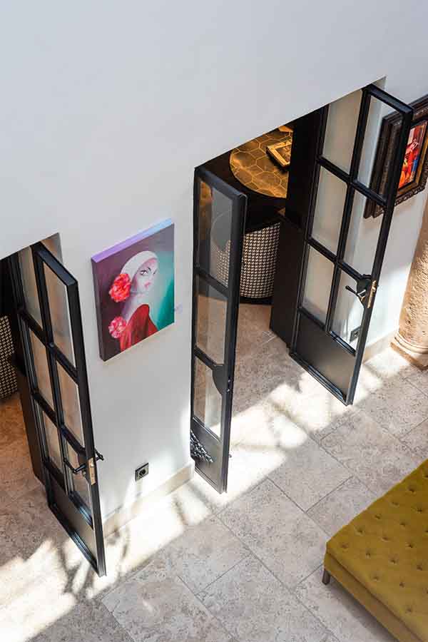 Overhead-view-courtyard-entrance-black-framed-doors-hotel-claude-marbella-spain-interior-design-boutique-hotel-design