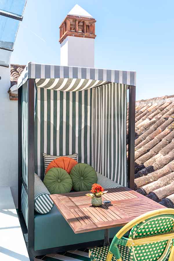 Rooftop-striped-cabana-daybed-green-cushions-hotel-claude-marbella-spain-boutique-hotel-design-interior-design