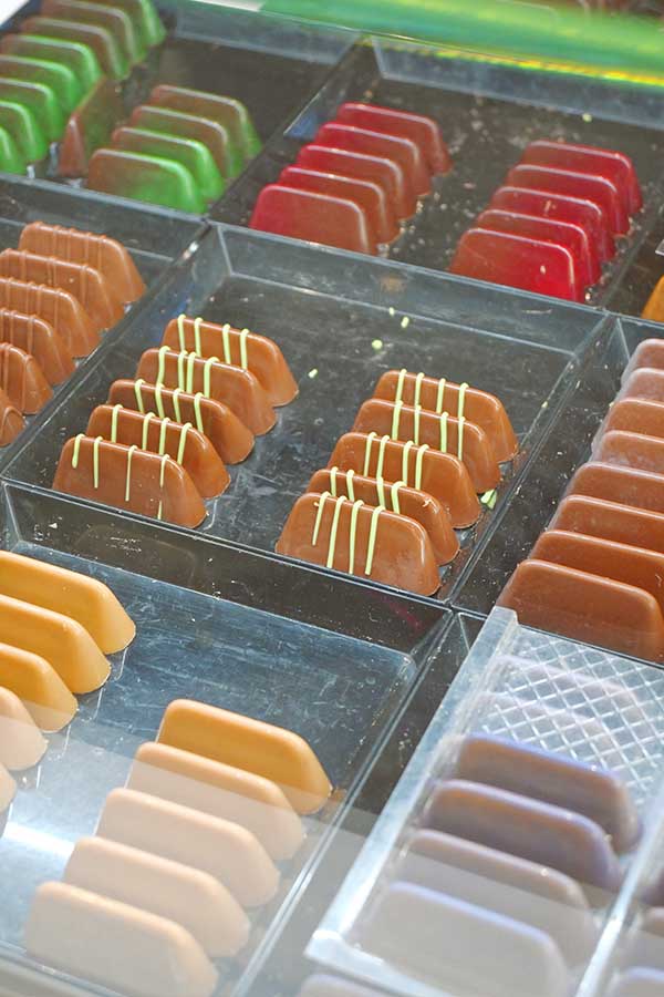 artisanal-french-chocolates-and-fruit-pates-arranged-in-a-boutique-display-case
