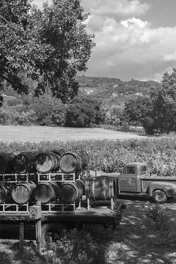 black-and-white-view-of-wine-barrels-and-a-vintage-pickup-truck-at-little-vineyards-family-winery-sonoma-valley-california