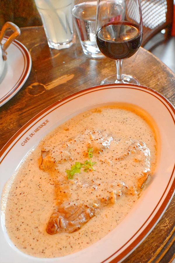 classic-french-steak-served-in-rich-creamy-mustard-sauce-with-red-wine-at-a-paris-bistro