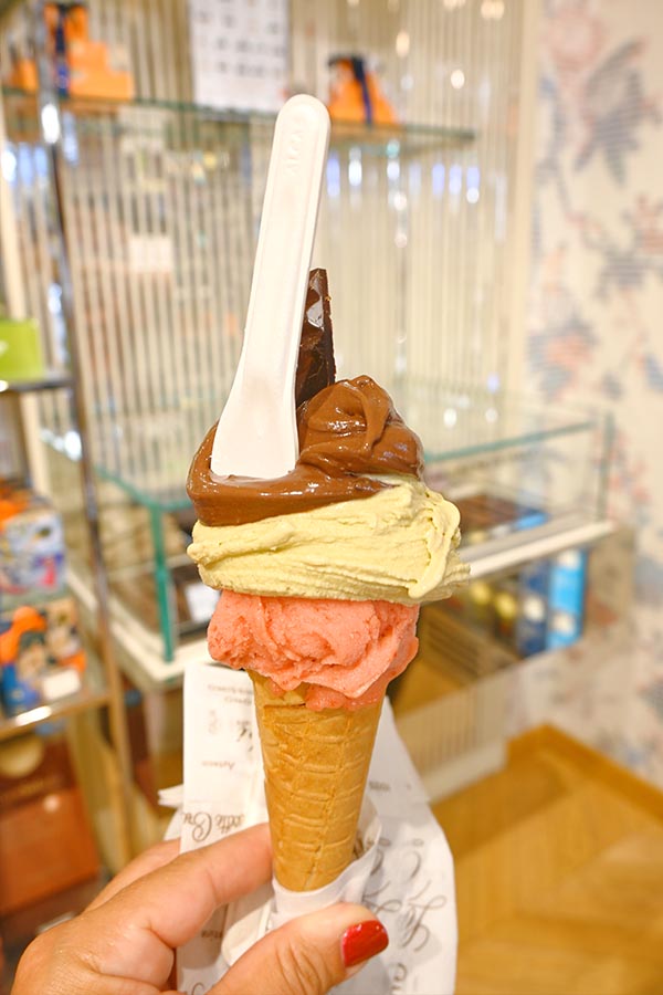 multi-layered-artisanal-gelato-cone-held-inside-a-french-gourmet-dessert-shop