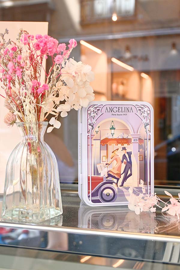 paris-france-angelina-tea-house-tin-box-displayed-beside-a-flower-vase-in-a-window