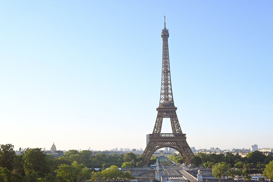paris-france-eiffel-tower-soaring-above-the-city-skyline-and-surrounding-greenery